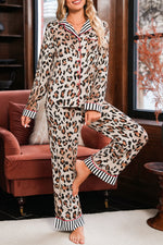 Load image into Gallery viewer, Woman wearing leopard print pajamas sitting on a couch.
